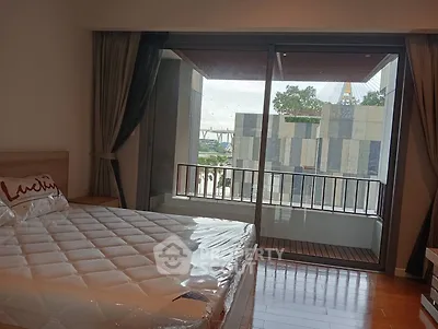 Modern bedroom with balcony and city view in a stylish apartment