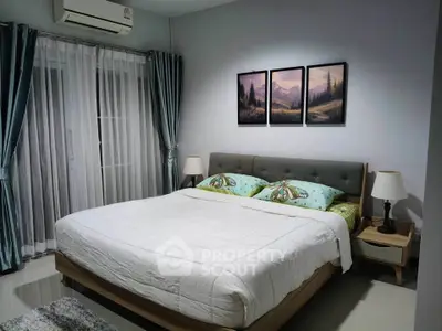 Cozy bedroom with elegant decor and large bed, featuring serene artwork and soft lighting.