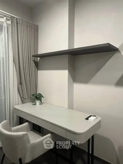Modern study area with sleek desk, chair, and floating shelf in a minimalist design.