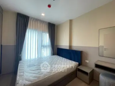 Modern bedroom with large window and stylish furnishings