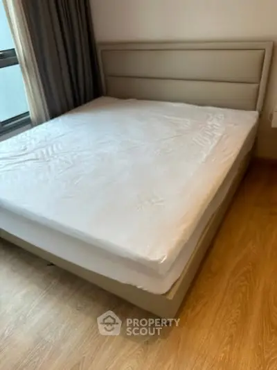 Spacious bedroom with modern bed and wooden flooring