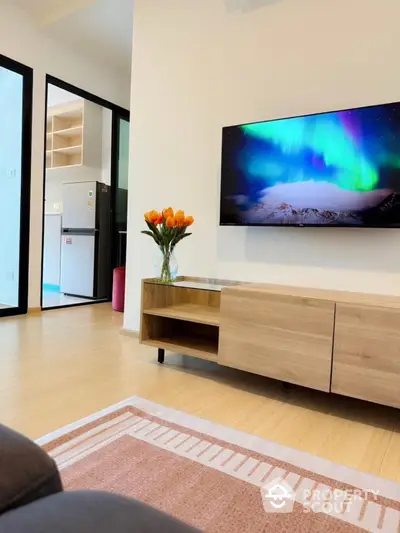 Modern living room with wall-mounted TV and stylish wooden furniture