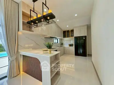 Luxurious modern kitchen with open layout and elegant lighting, featuring sleek cabinetry and a spacious countertop.