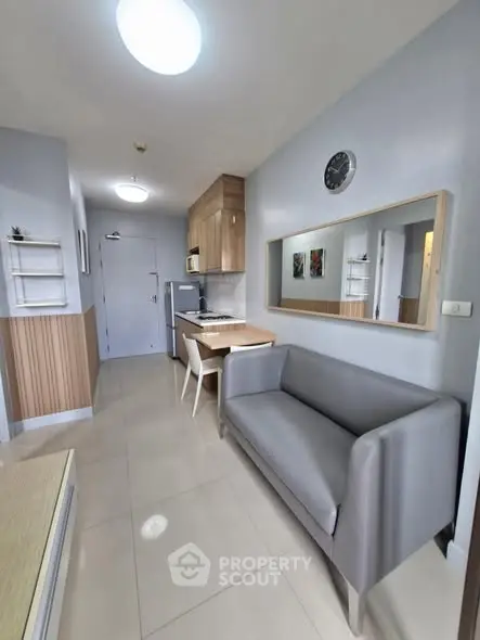 Modern apartment interior with sleek kitchen and cozy living area, ideal for urban living.