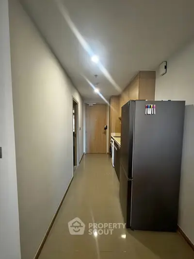 Modern hallway with sleek appliances and stylish lighting