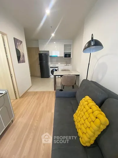 Modern apartment interior with cozy living area and compact kitchen