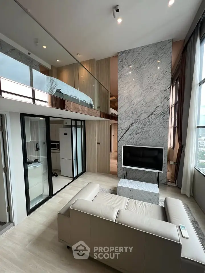Luxurious modern living room with high ceilings and mezzanine in a stylish apartment
