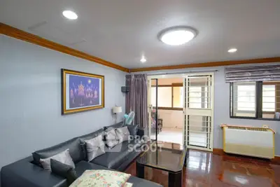 Spacious living room with modern decor and ample natural light