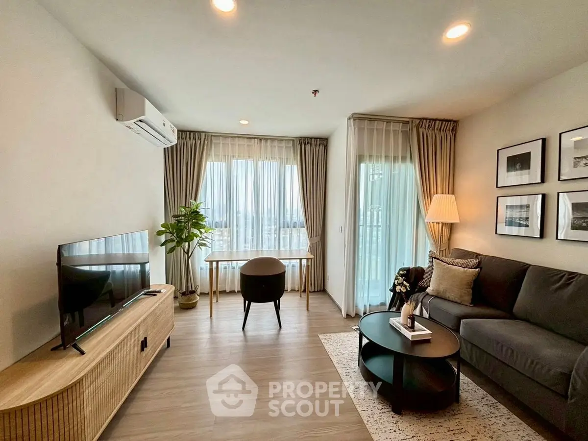 Modern living room with stylish decor and large windows offering natural light.