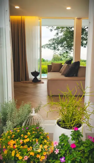 Luxurious living room with garden view, featuring elegant decor and floor-to-ceiling windows.