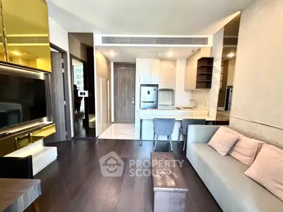 Modern living room with open kitchen, sleek design, and stylish furniture in a contemporary apartment.