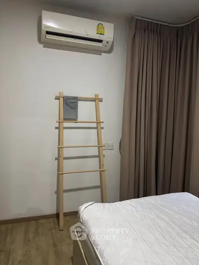 Cozy bedroom with air conditioning and modern decor, perfect for relaxation and comfort.