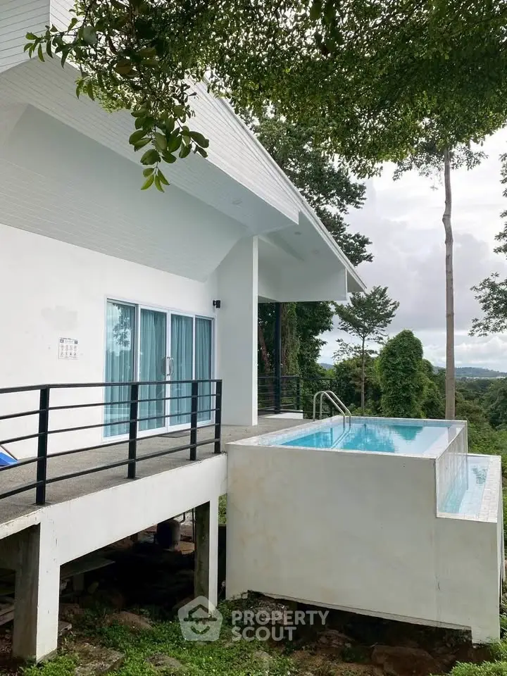 Stunning modern home with private infinity pool and lush forest views.