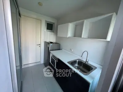 Compact modern kitchen with sleek cabinetry and stainless steel sink