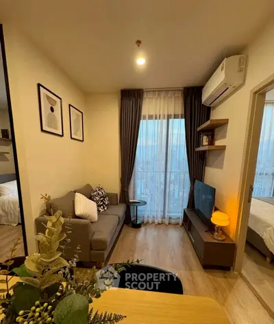 Cozy living room with modern decor and city view, featuring a comfortable sofa and stylish furnishings.