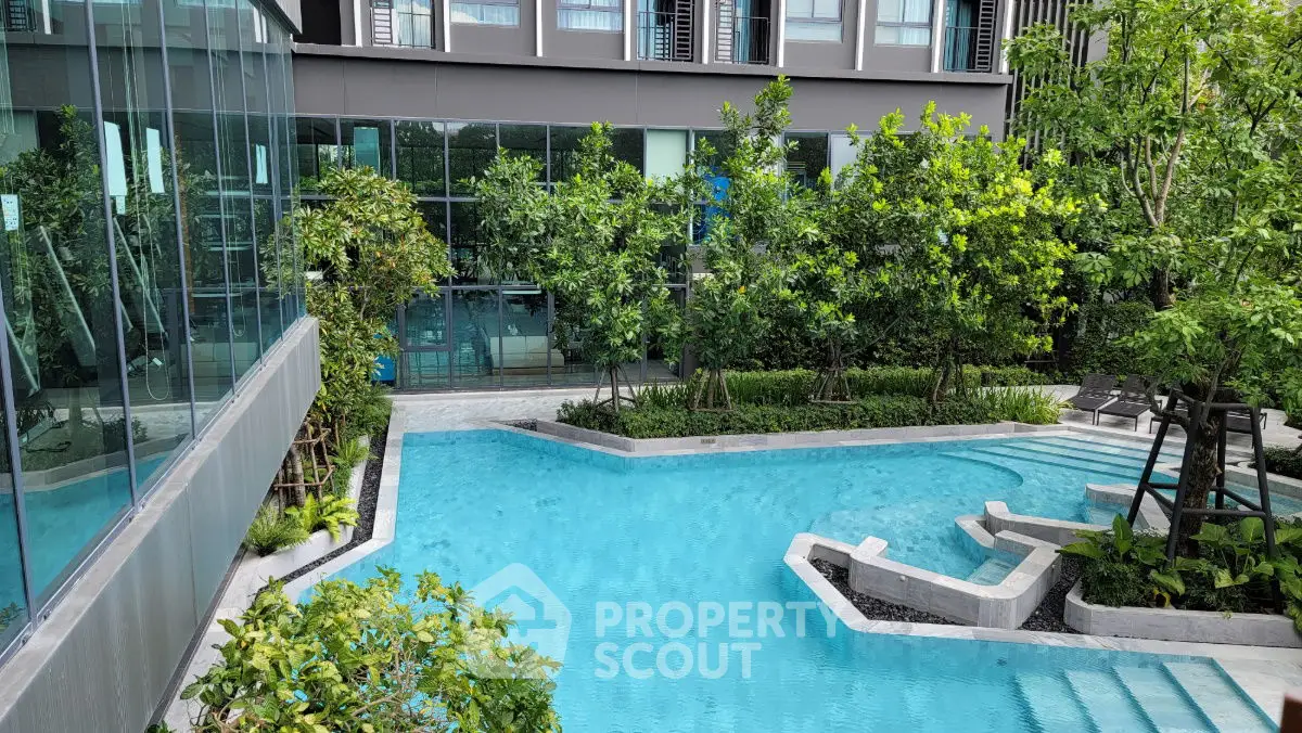 Luxurious condominium with stunning pool and lush greenery, perfect for relaxation and leisure.
