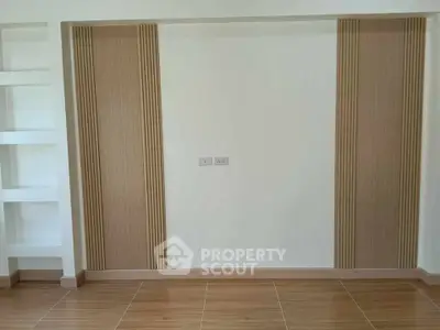Modern minimalist interior wall with wood panel accents and built-in shelving