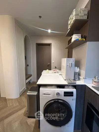 Modern kitchen with washing machine and sleek cabinetry