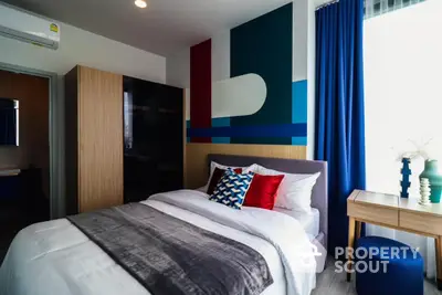 Modern bedroom with colorful accent wall and stylish decor