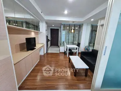 Modern living room with sleek furniture and wooden flooring in a stylish apartment.