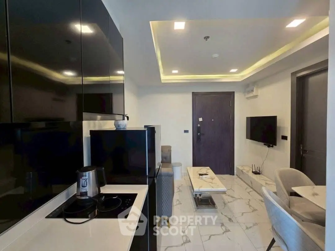 Modern open-layout kitchen and living room with sleek design and contemporary furnishings.