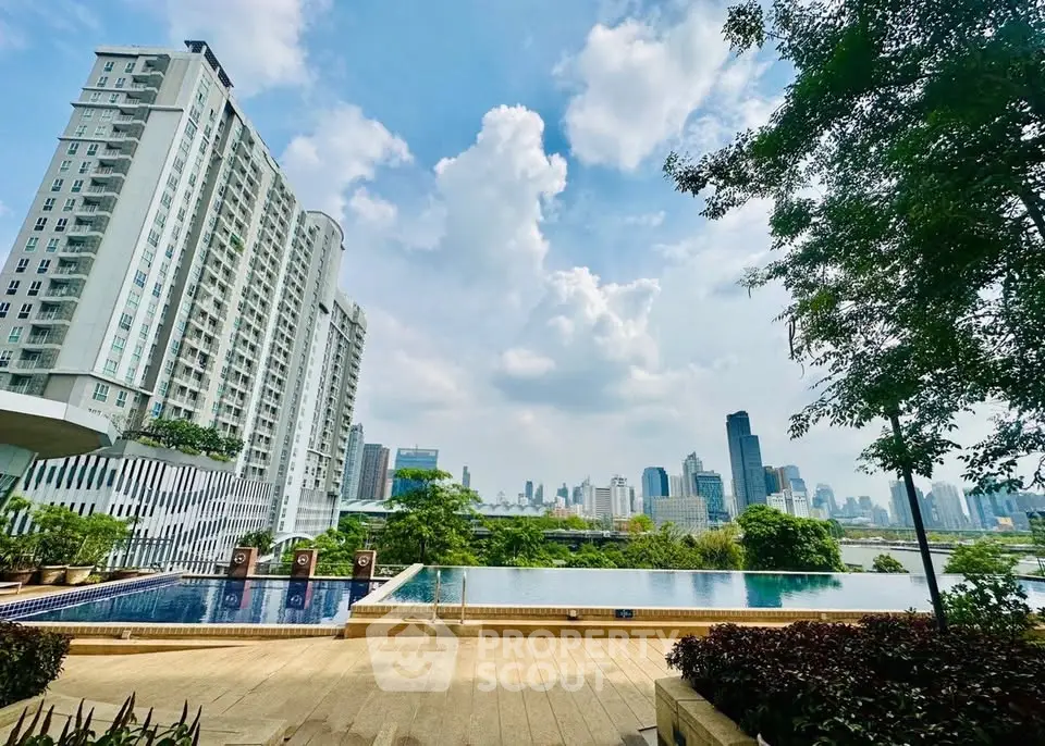 Luxurious high-rise building with stunning pool and city skyline view, perfect for urban living.