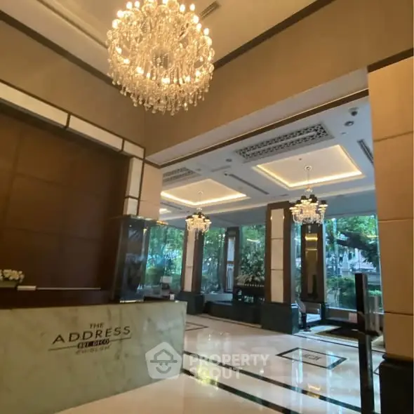 Luxurious building entrance with elegant chandeliers and modern design