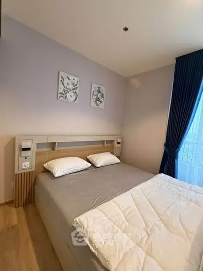 Cozy bedroom with modern decor and large window for natural light