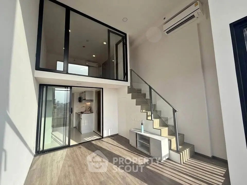 Modern duplex apartment with high ceilings and large windows for natural light