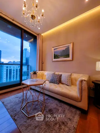 Luxurious living room with elegant chandelier and stunning city view from balcony.