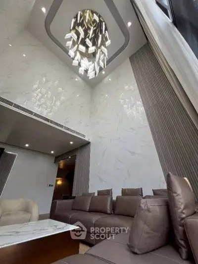 Luxurious living room with high ceiling and elegant chandelier