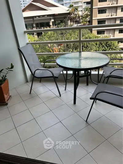 Charming balcony with seating and scenic view, perfect for relaxation.