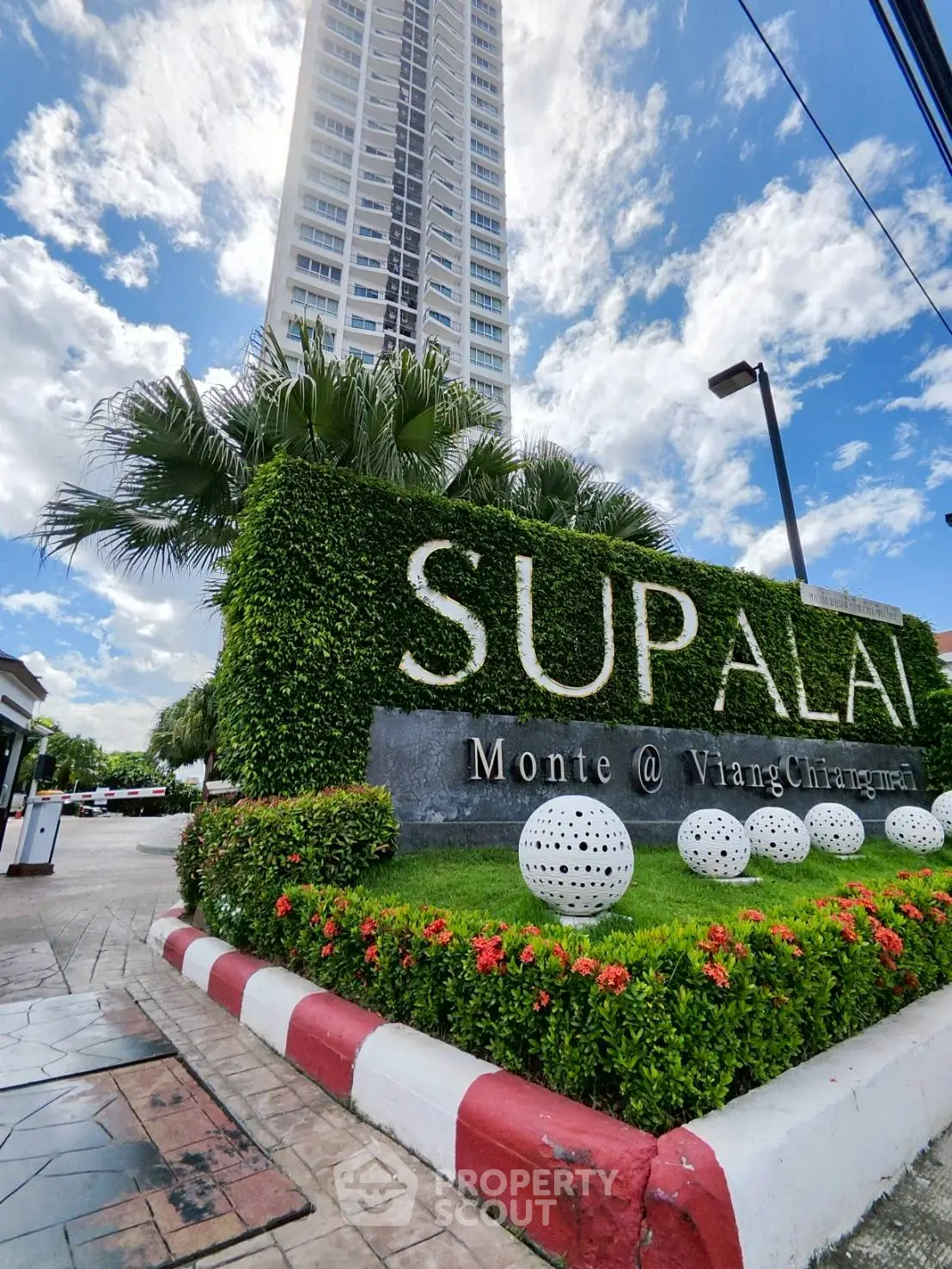 Stunning high-rise building with lush landscaping at Supalai Monte, offering modern urban living.