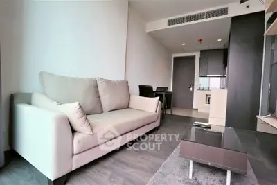 Modern living room with sleek furniture and open kitchen layout