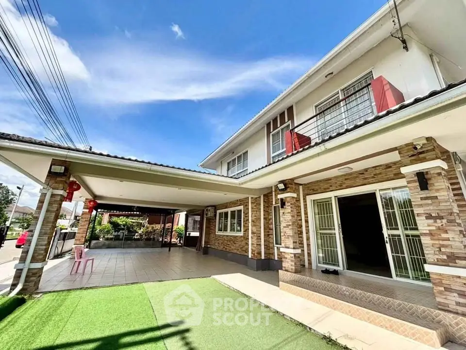 Spacious two-story home with covered patio and lush green lawn, perfect for family living.