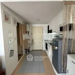 Modern kitchen with sleek appliances and open layout, featuring a stylish fridge and ample storage space.