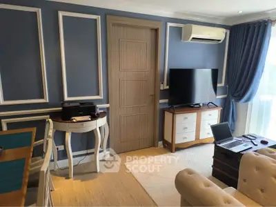 Charming living room with elegant blue walls, modern furniture, and natural light.