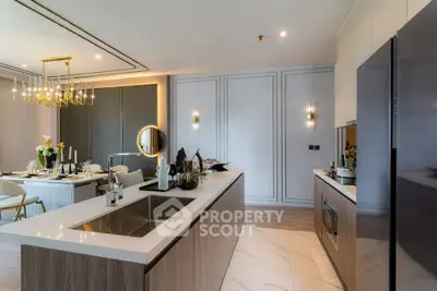 Luxurious open kitchen with modern dining area and elegant lighting