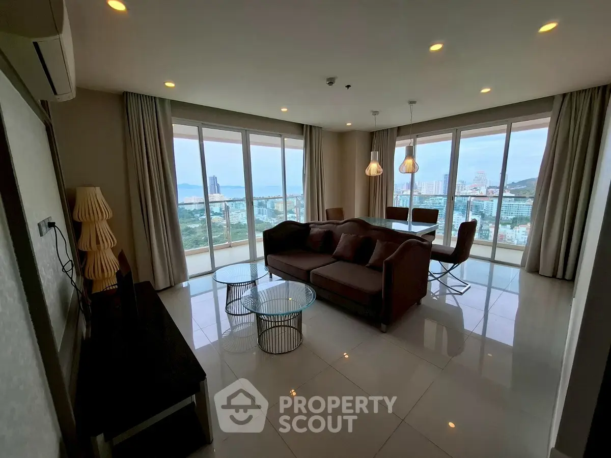 Spacious living room with panoramic city views and modern furnishings
