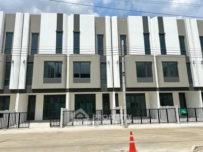 Modern townhouse exterior with sleek design and large windows, perfect for urban living.