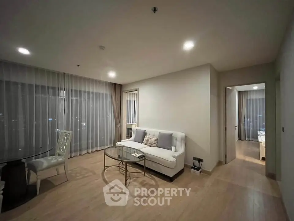 Modern living room with elegant decor and cozy ambiance in a stylish apartment.
