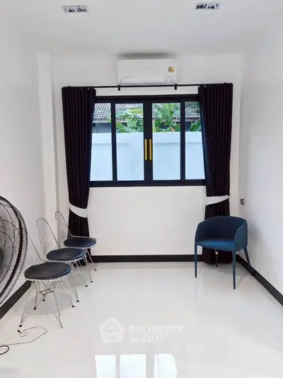 Bright and airy room with modern seating and air conditioning, perfect for a cozy living space.