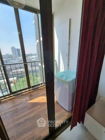 Modern apartment balcony with city view and washing machine, perfect for urban living.