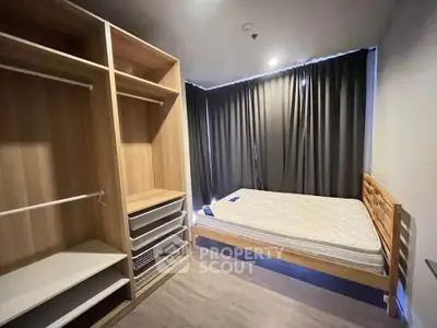 Modern bedroom with wooden wardrobe and bed, featuring sleek design and ample storage space.