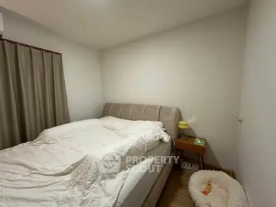 Cozy bedroom with modern bed and soft lighting, perfect for relaxation.