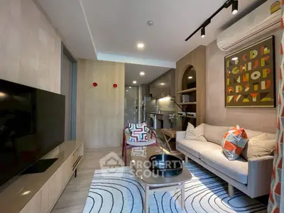 Modern living room with stylish decor and open kitchen layout in a cozy apartment.