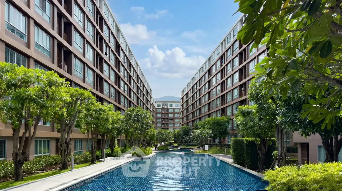 Luxurious apartment complex with stunning pool and lush greenery