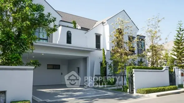 Elegant modern house with lush greenery and spacious driveway