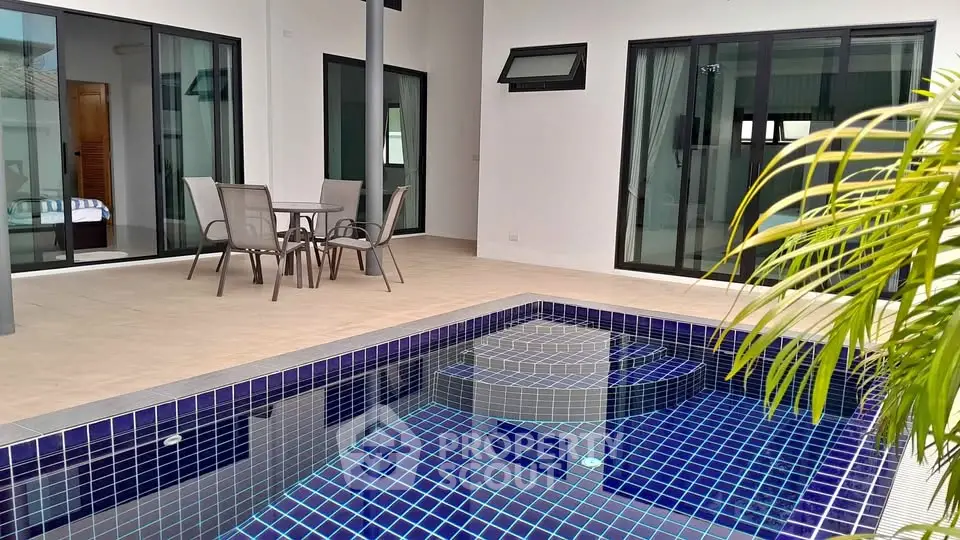 Luxurious modern patio with private pool and stylish outdoor seating area.