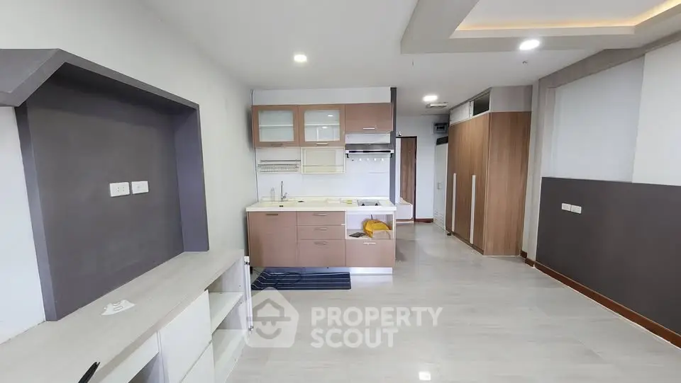 Modern open-plan kitchen with sleek cabinetry and ample storage space.